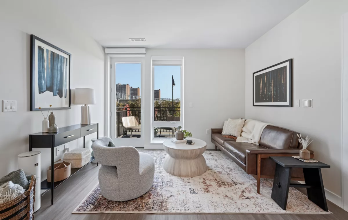 Living room with abundant natural light from floor-to-ceiling windows with roller shades