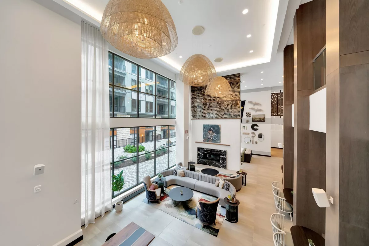 High-angle view of a modern lounge with a fireplace, seating, and large windows.
