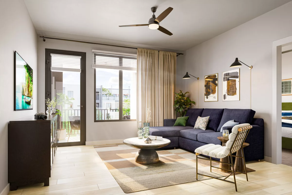 Contemporary living room with a navy sectional, accent chair, round coffee table, and balcony access through glass doors.