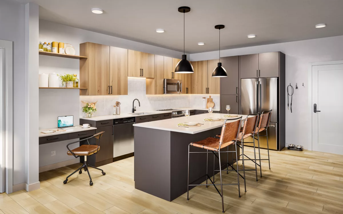 Modern kitchen with wood and dark cabinetry, island seating, pendant lighting, and a built-in workspace with a laptop.