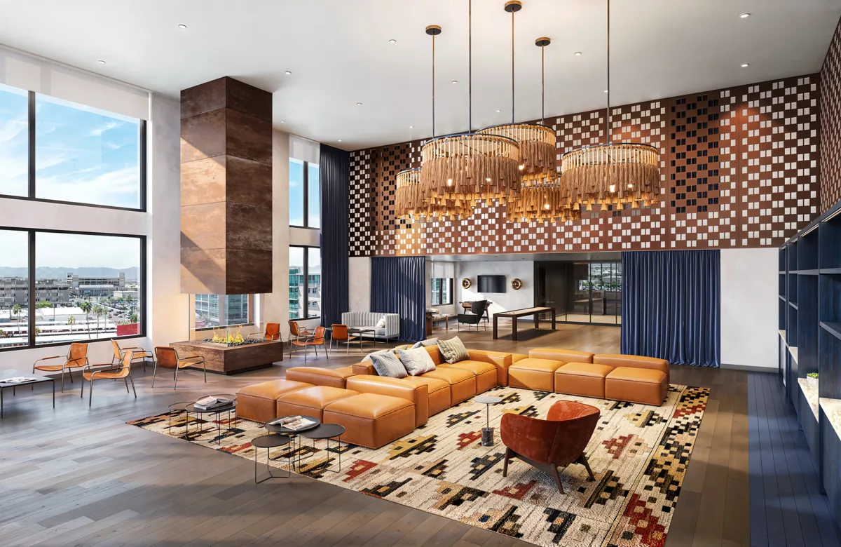 Spacious clubroom with leather seating, tall fireplace, and large patterned wall.