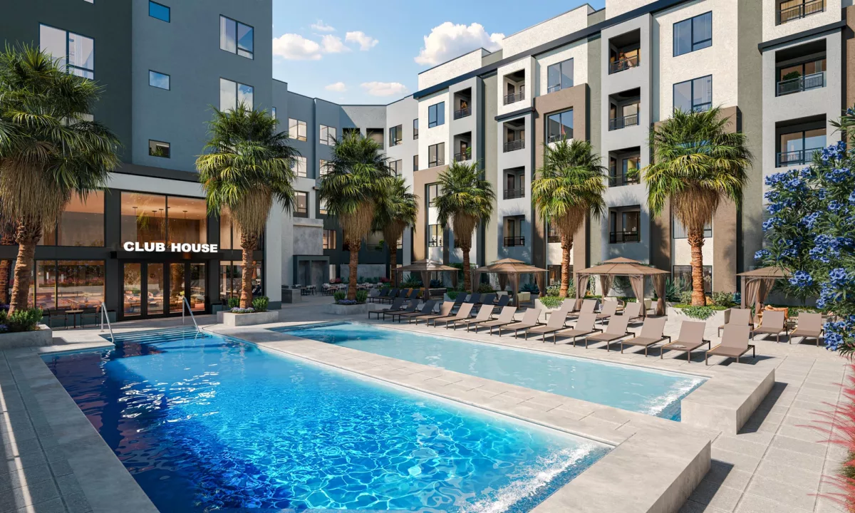 Outdoor pool courtyard with lounge chairs, palm trees, and the club house entry.