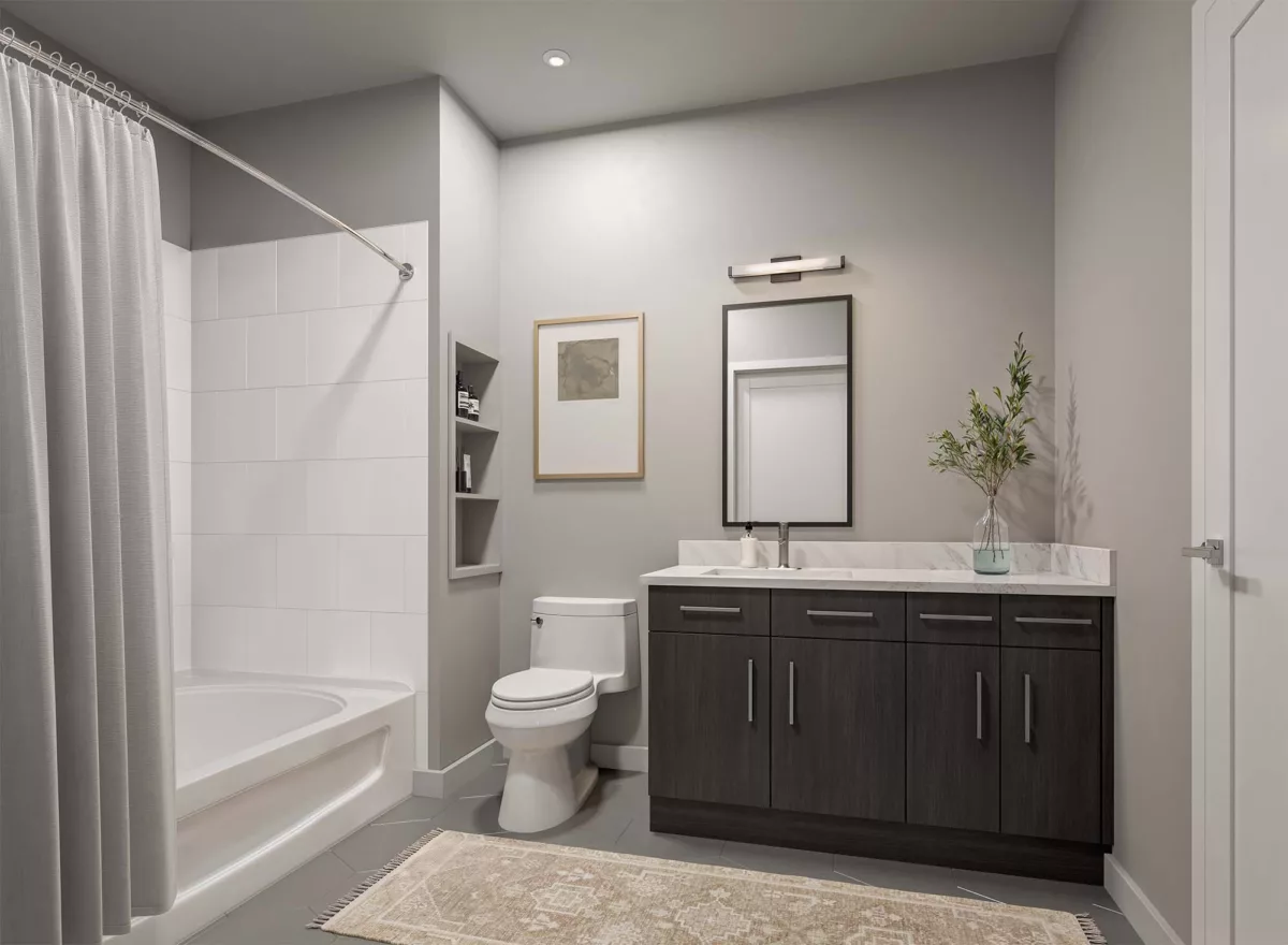 Neutral bathroom with vanity, tub and shower curtain, wall shelving, and framed artwork.