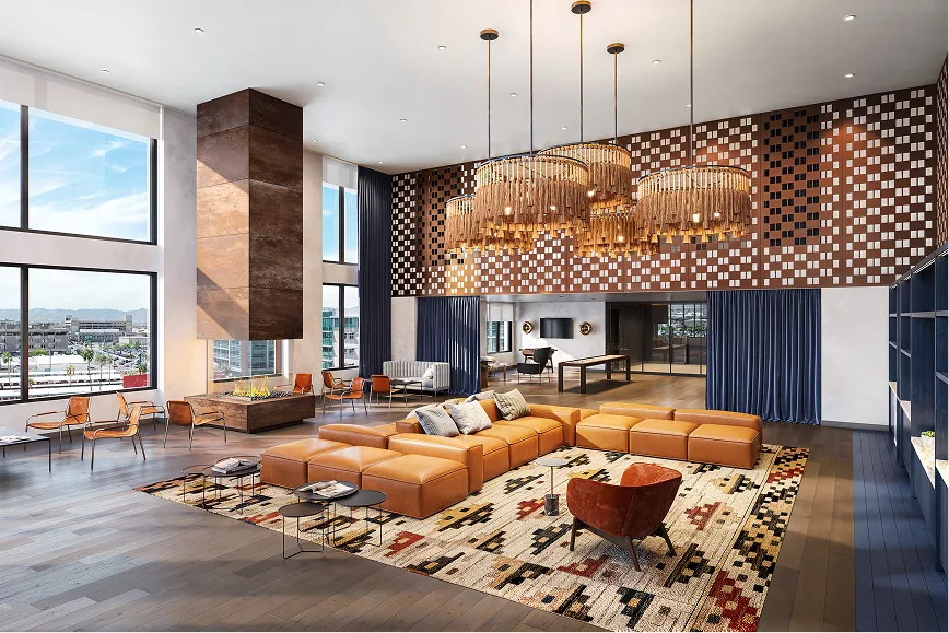 Spacious lounge with leather sofas, large windows, and chandeliers