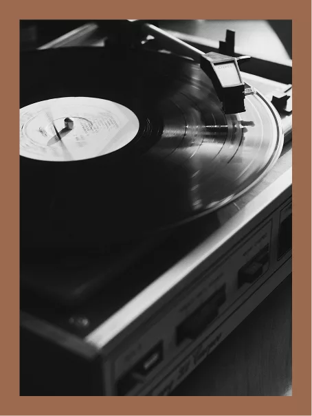 Black and white close-up of a vinyl record spinning on a turntable