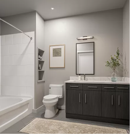 Modern bathroom with dark vanity, white bathtub, and neutral décor
