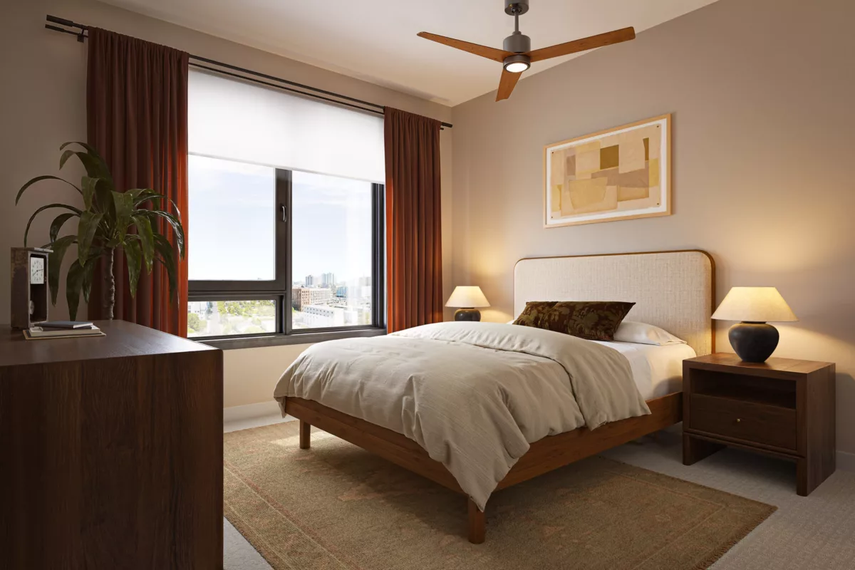 Bedroom with a large window, ceiling fan, and a bed with a light-colored headboard.