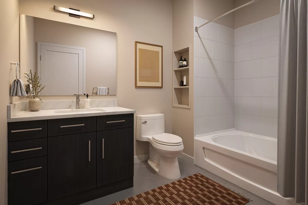 Modern bathroom with dark wood vanity, white quartz countertop, and a tiled tub/shower combo.