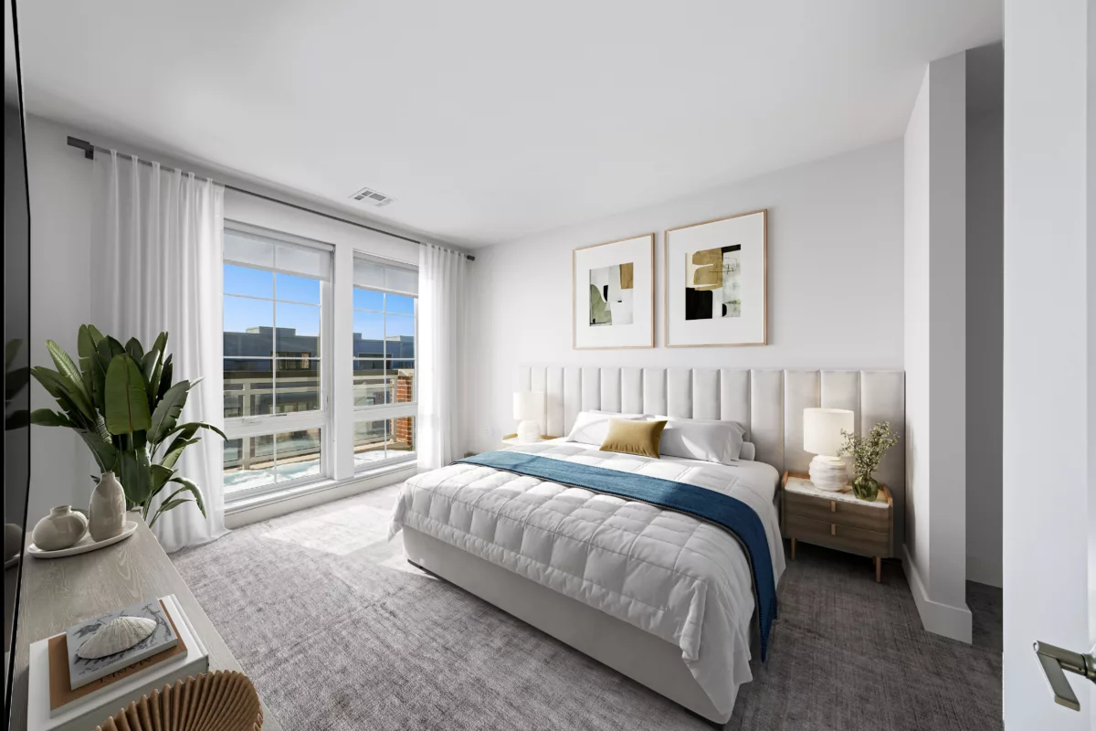 Modern bedroom with a large bed, upholstered headboard, two nightstands, and a large window.