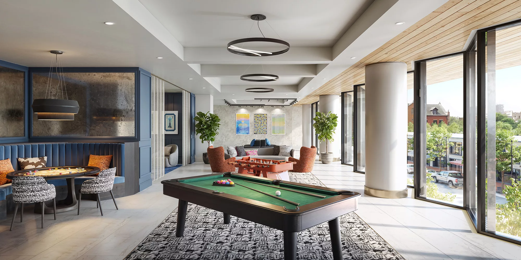 Modern lounge with pool table, seating area, large windows, and city views
