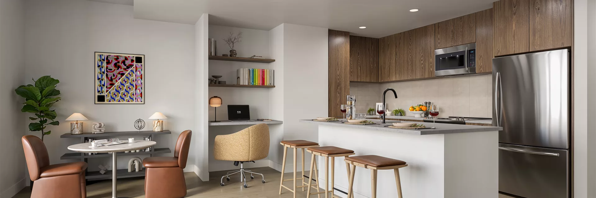 Open kitchen and dining area with bar seating and workspace nook