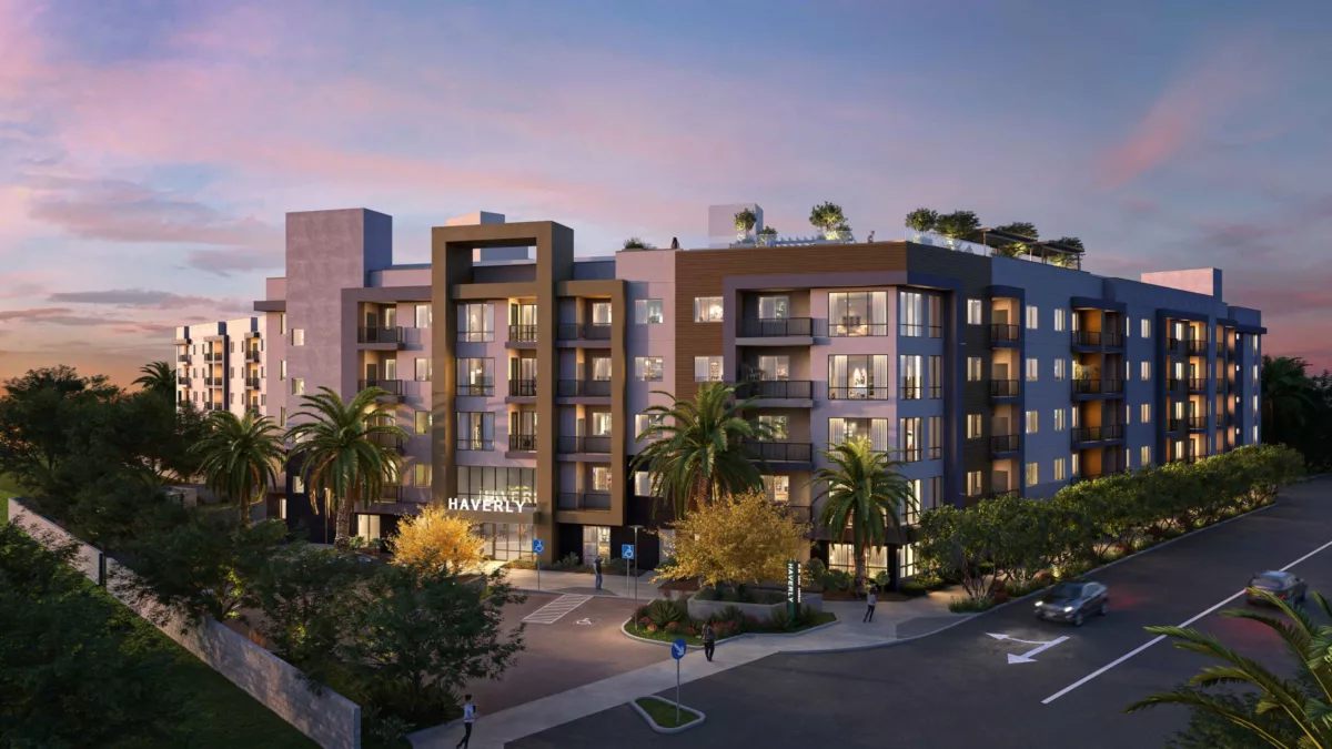 Sleek, modern apartment complex at twilight, with palm trees and rooftop amenities, illuminated by soft exterior lighting.