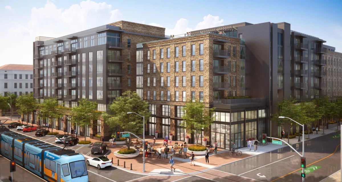 A high-rise mixed-use development with a luxury retail base, dramatic lighting, glass tower residences above, and palm trees on a rooftop terrace at dusk.