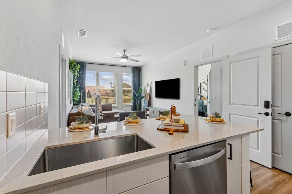 View from kitchen island into living room with large windows