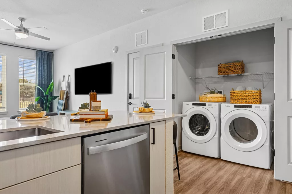 Laundry closet with washer, dryer, and storage baskets