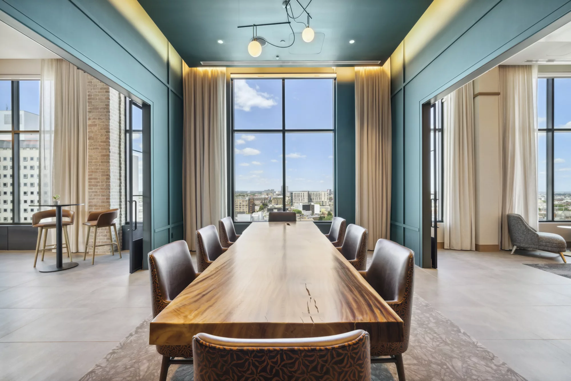 Elegant meeting room with long wood table and tall windows