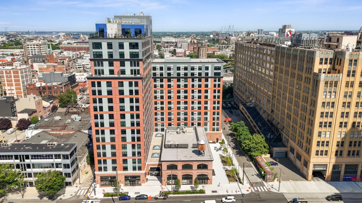 Aerial view of a tall modern apartment building in an urban area
