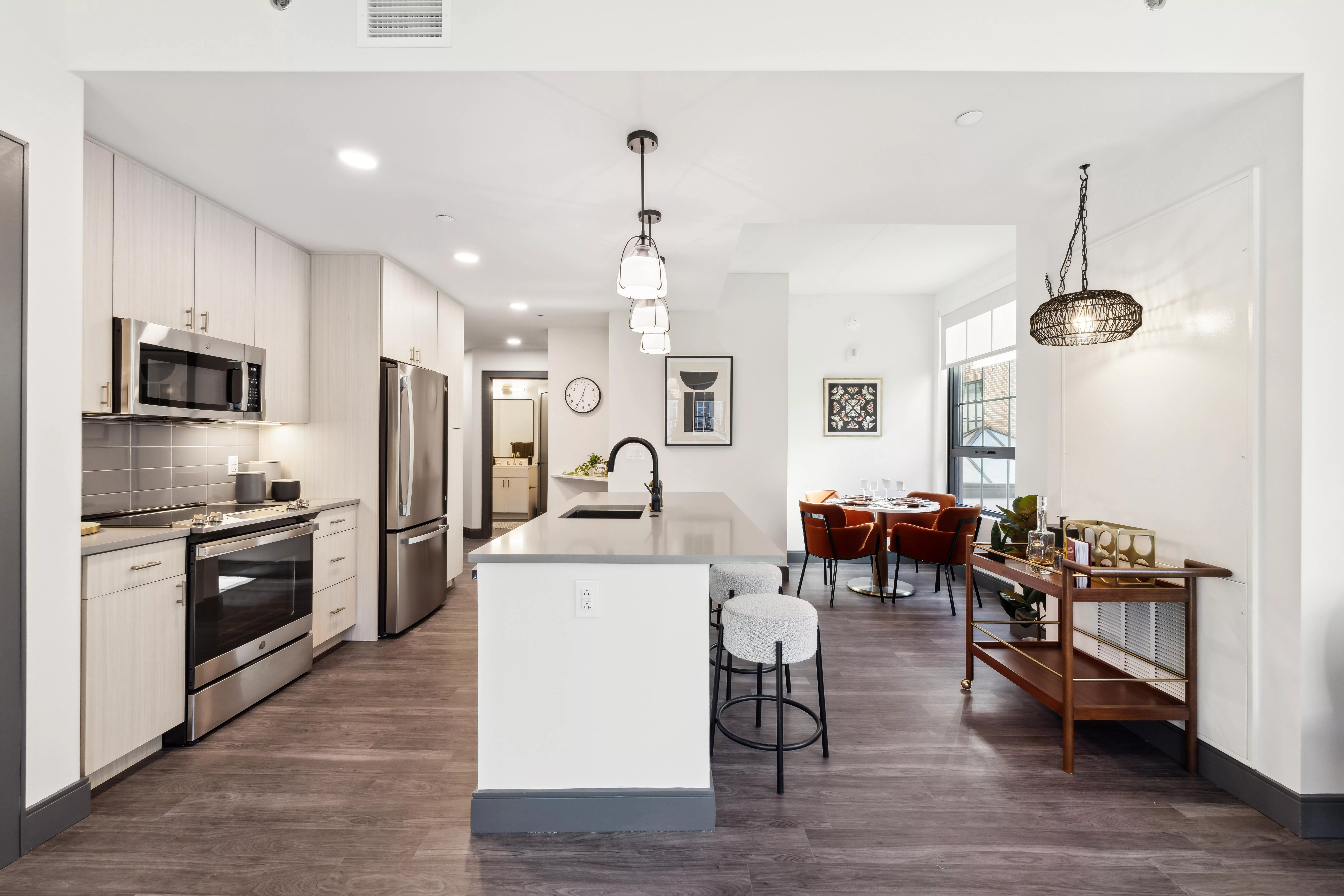 Modern kitchen with island seating and adjacent dining area