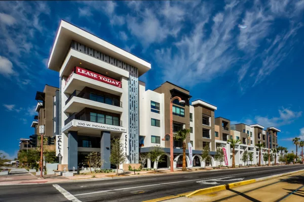 Modern apartment building with balconies and leasing banners