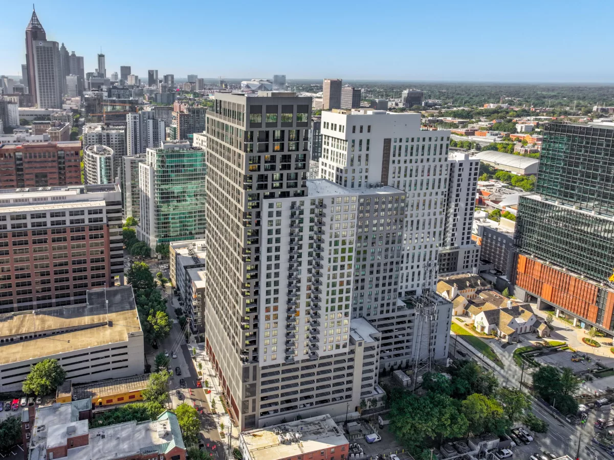 High-rise apartments in a dense cityscape with skyline view in background.
