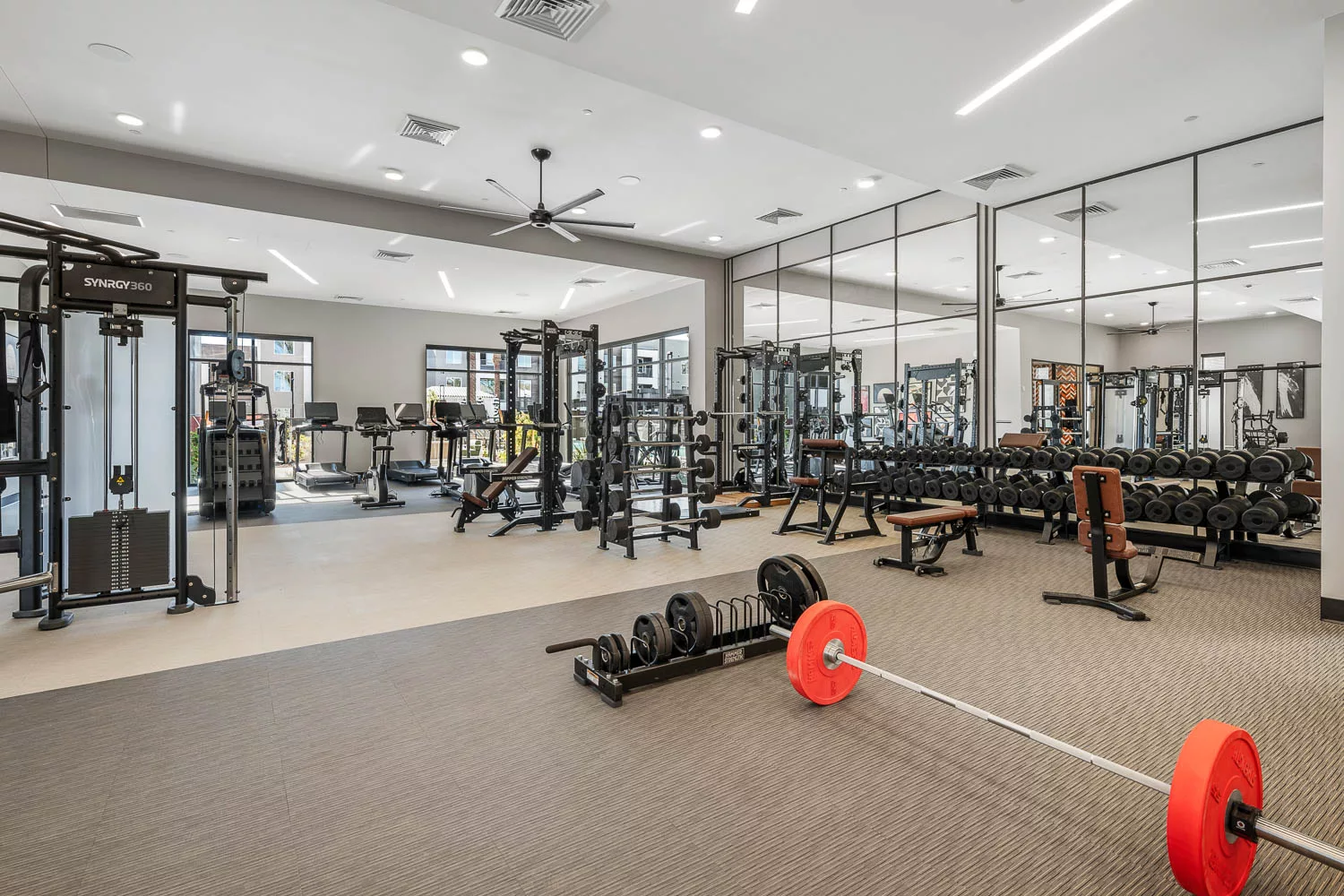 Spacious fitness center with free weights and cardio equipment.