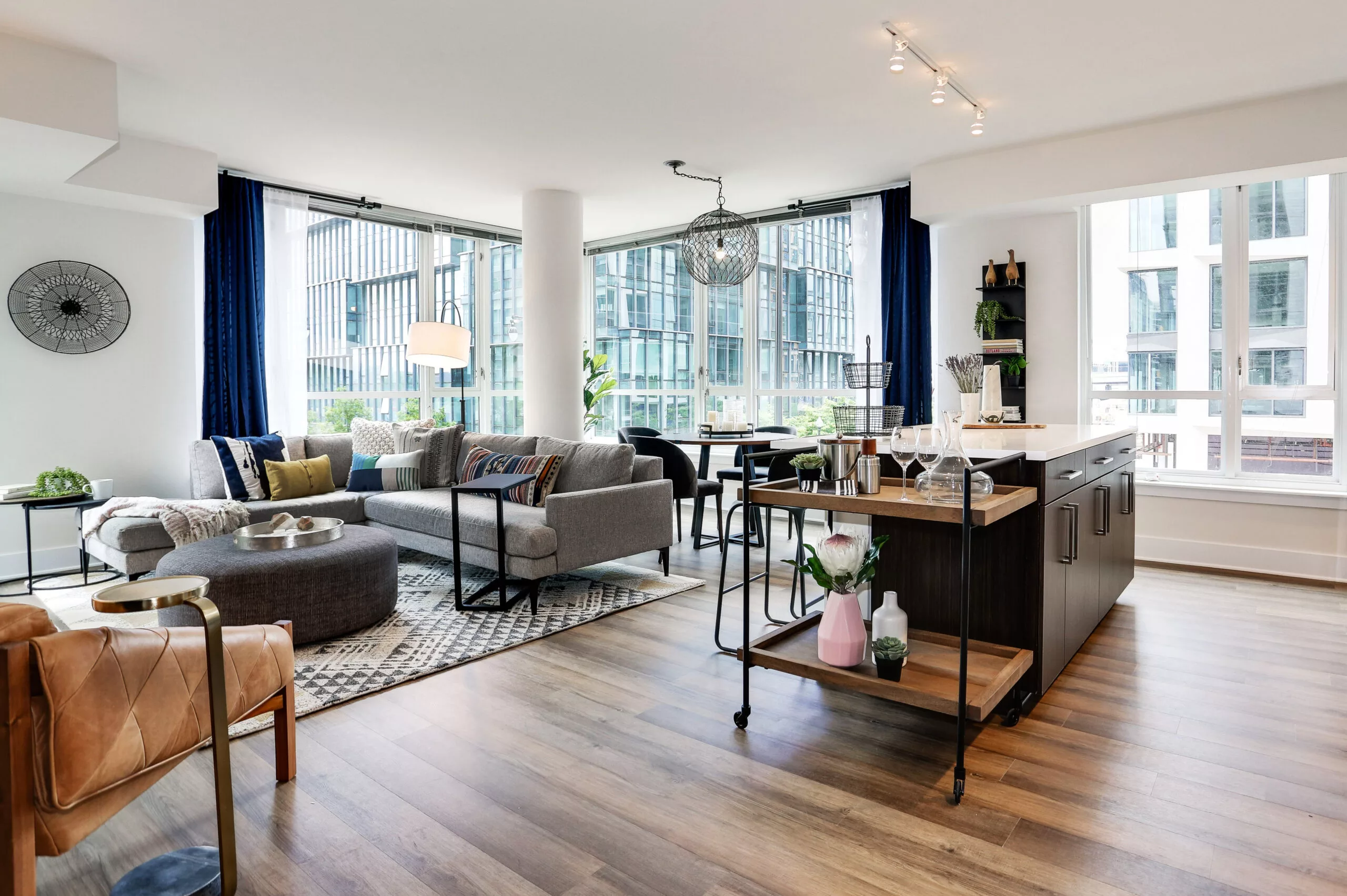 Model living room at Parc Riverside with large windows and open floor plan