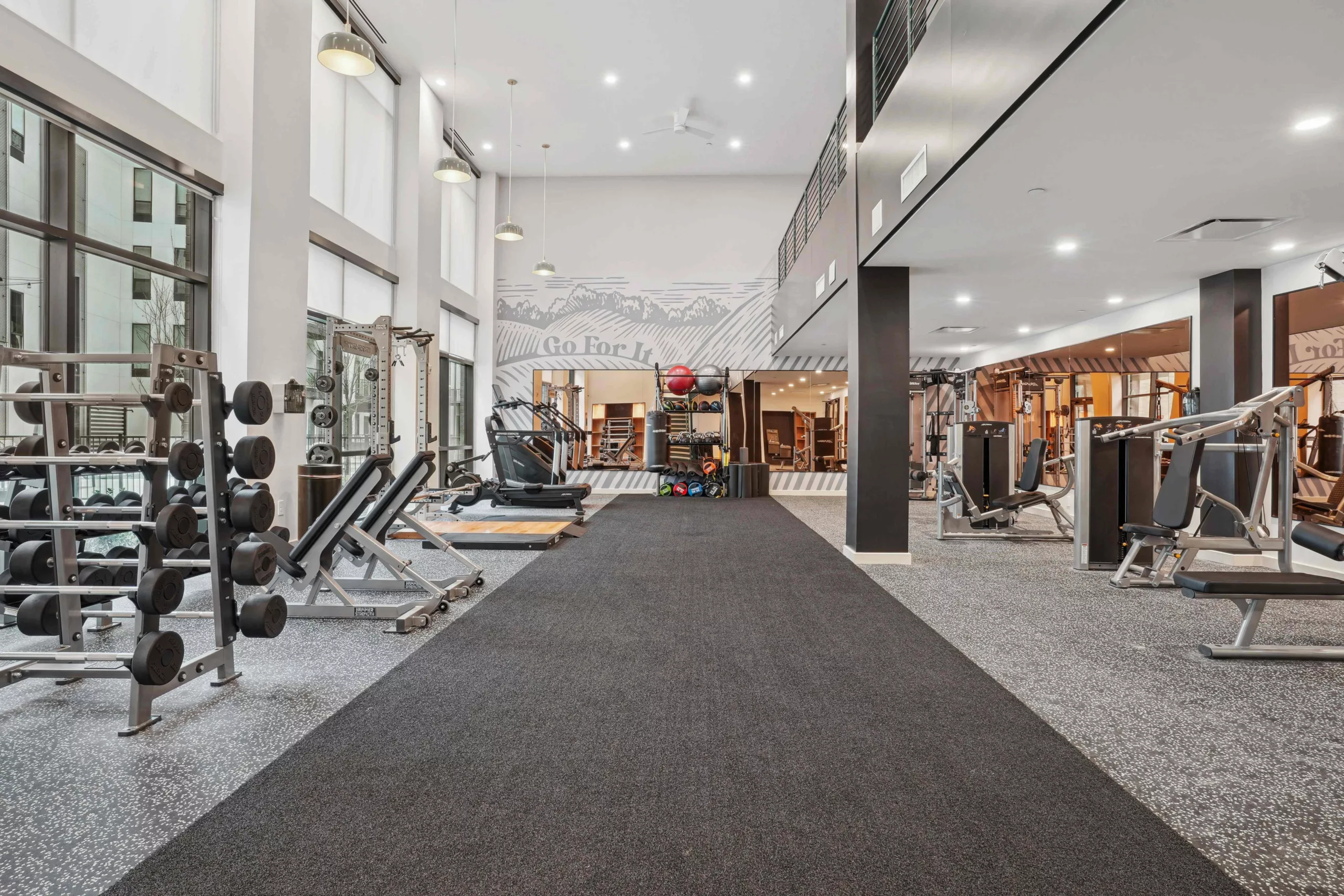 Spacious fitness center with free weights and cardio machines.