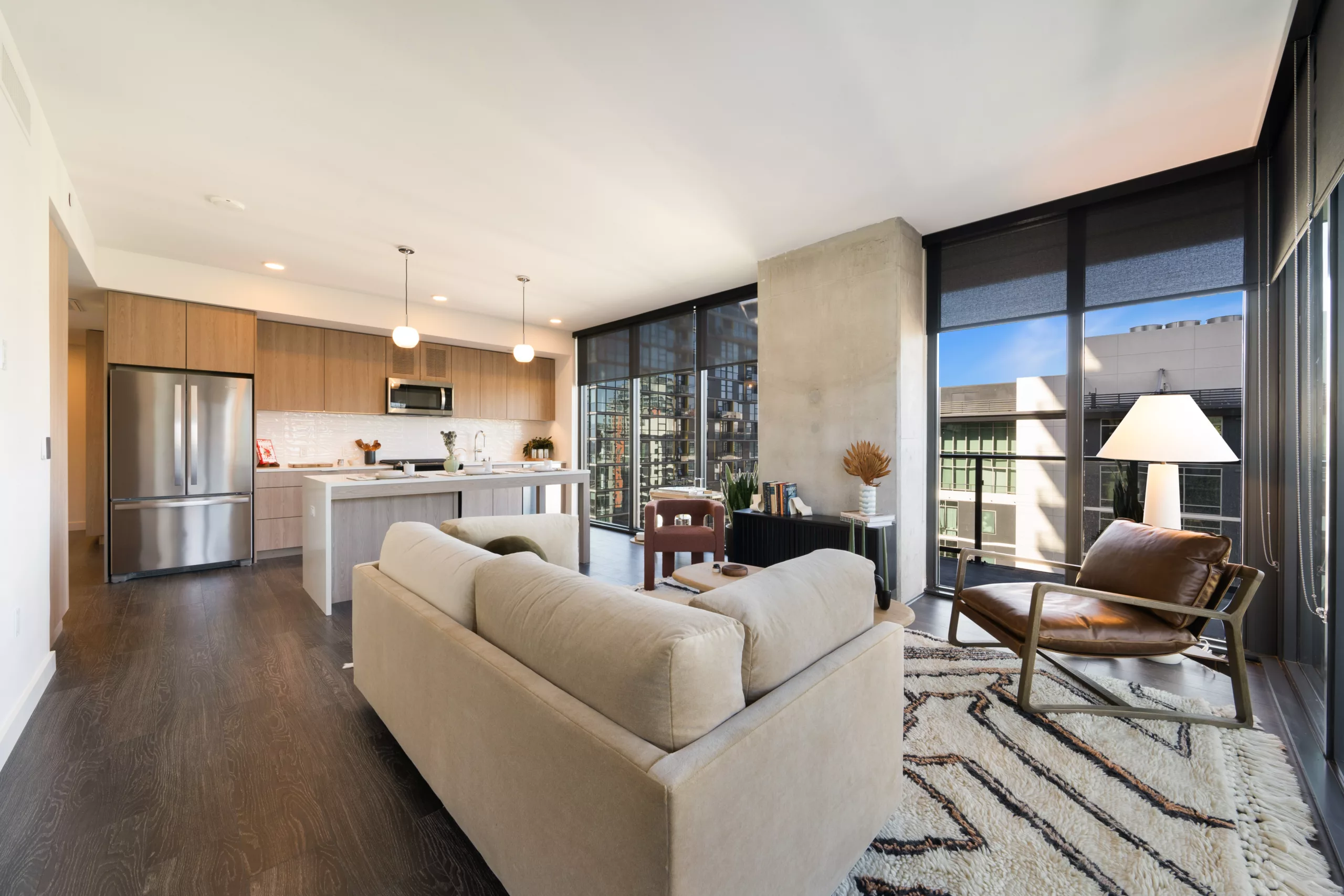 Open living room and kitchen with floor-to-ceiling windows