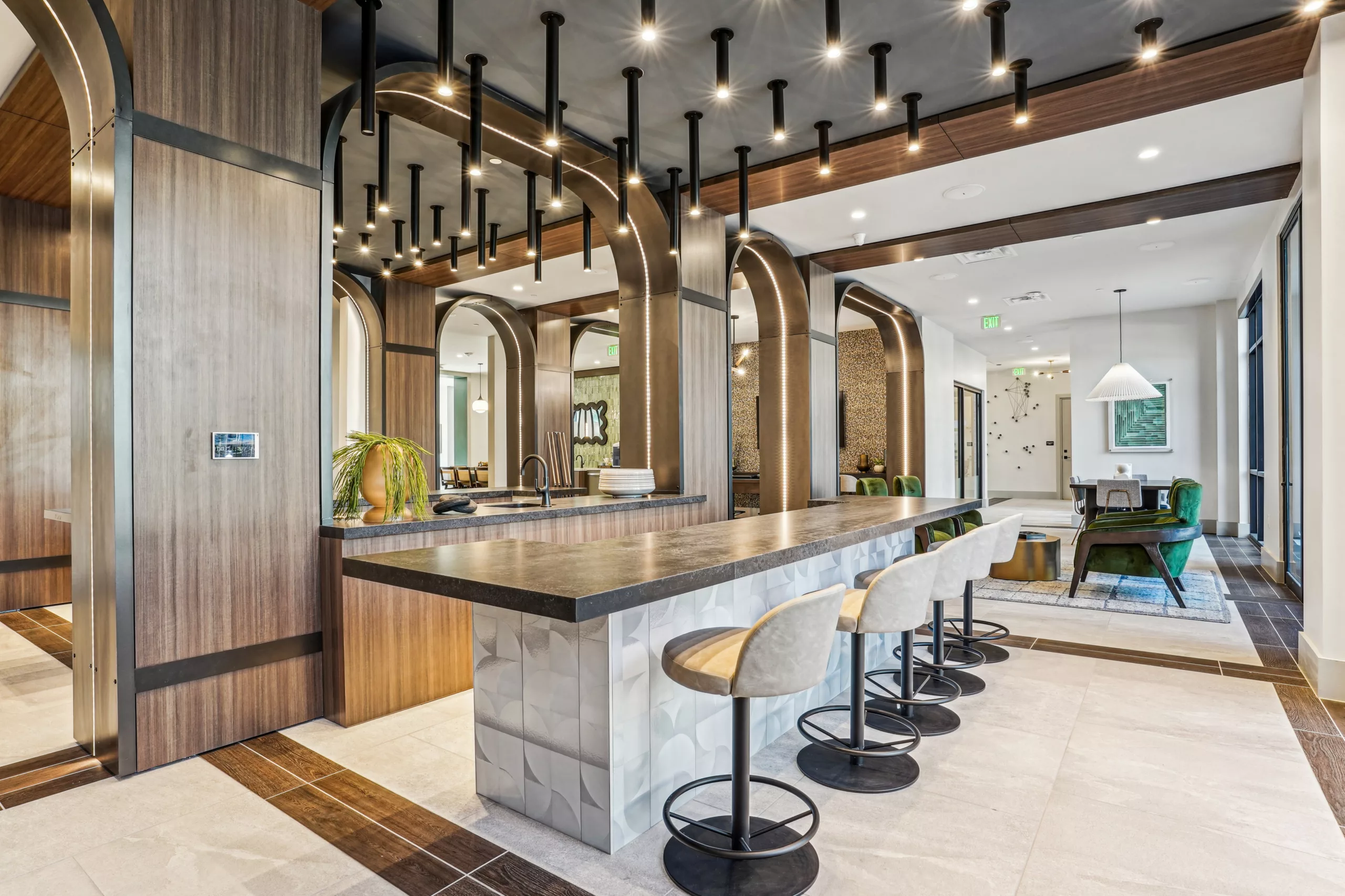 Contemporary bar area with pendant lights and tall archways