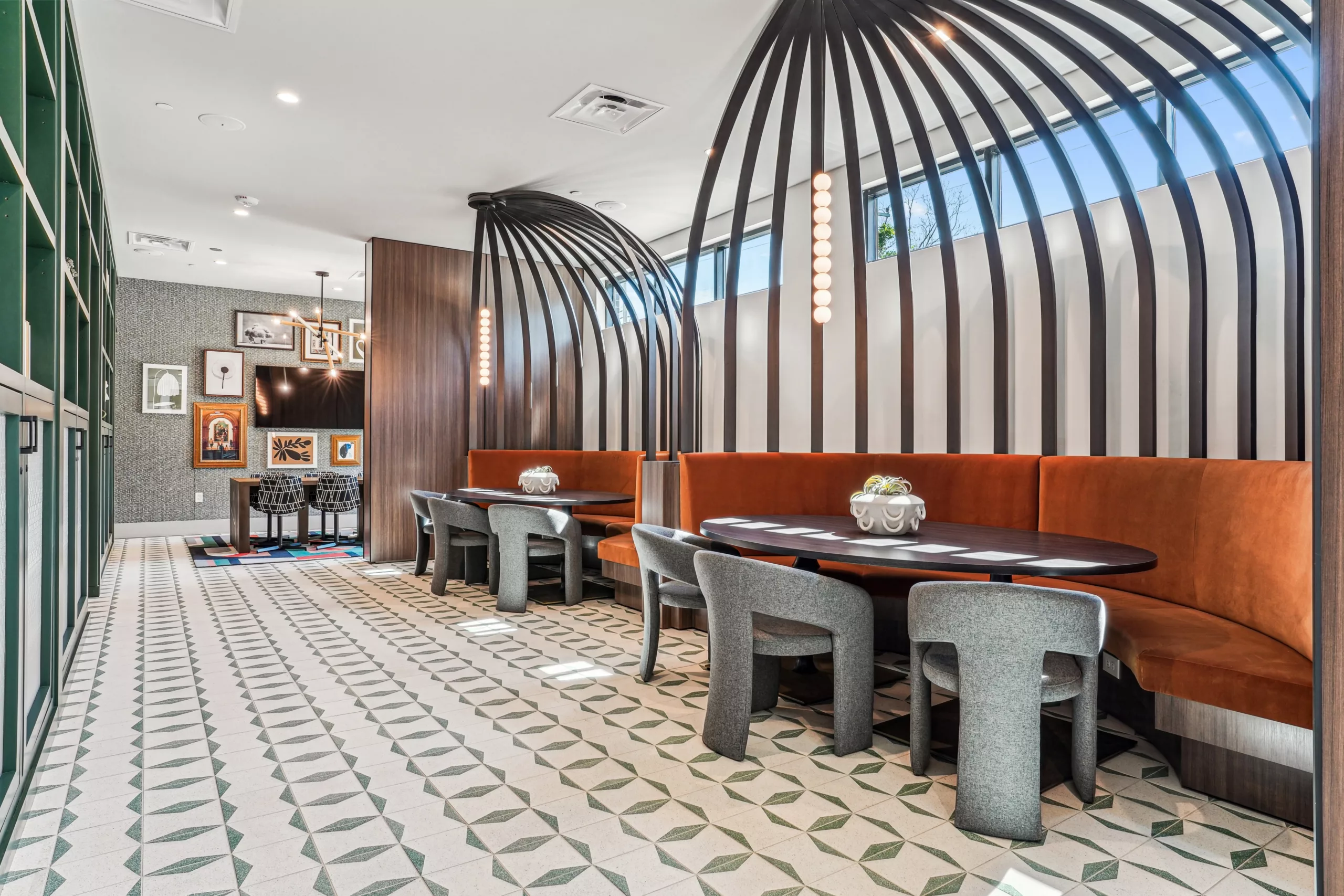 Booth seating area with curved wood dividers and wall decor