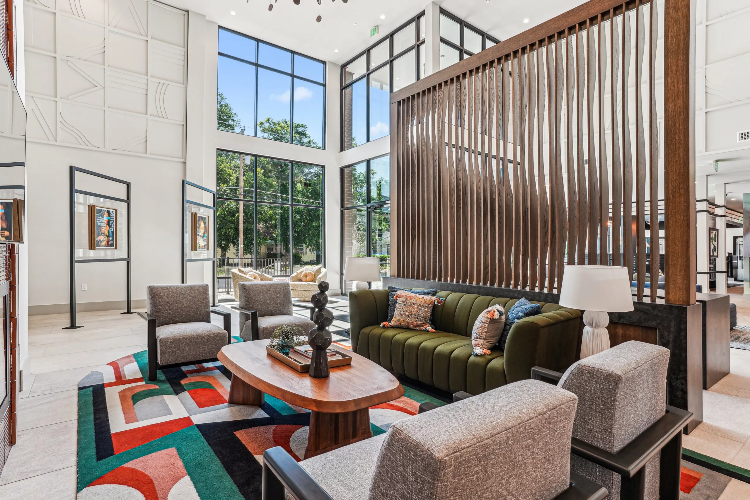 Lobby with tall windows, modern furniture, and wood divider
