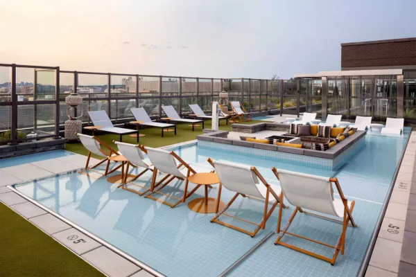 Rooftop pool with lounge seating at Parc Riverside
