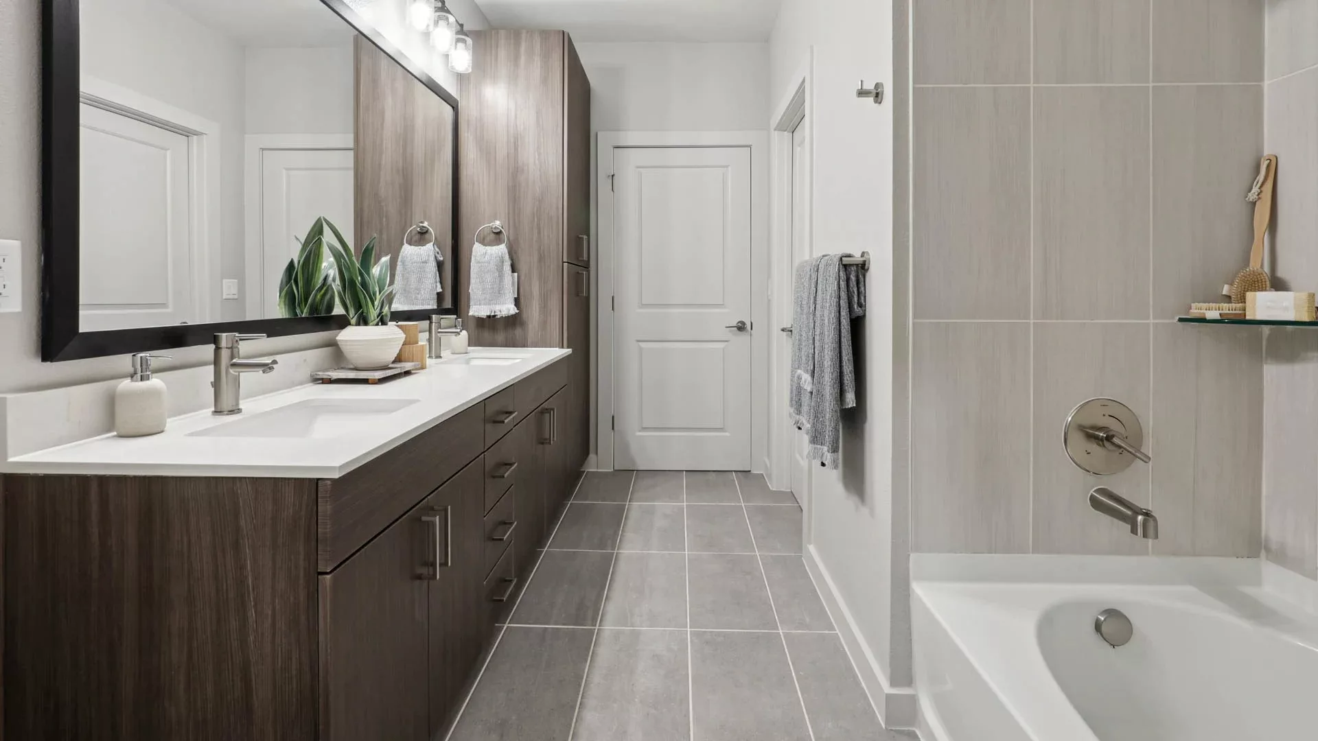 Bathroom with double vanity and bathtub in modern neutral design