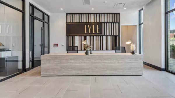 Modern reception desk with “LYLE” sign and decorative lighting