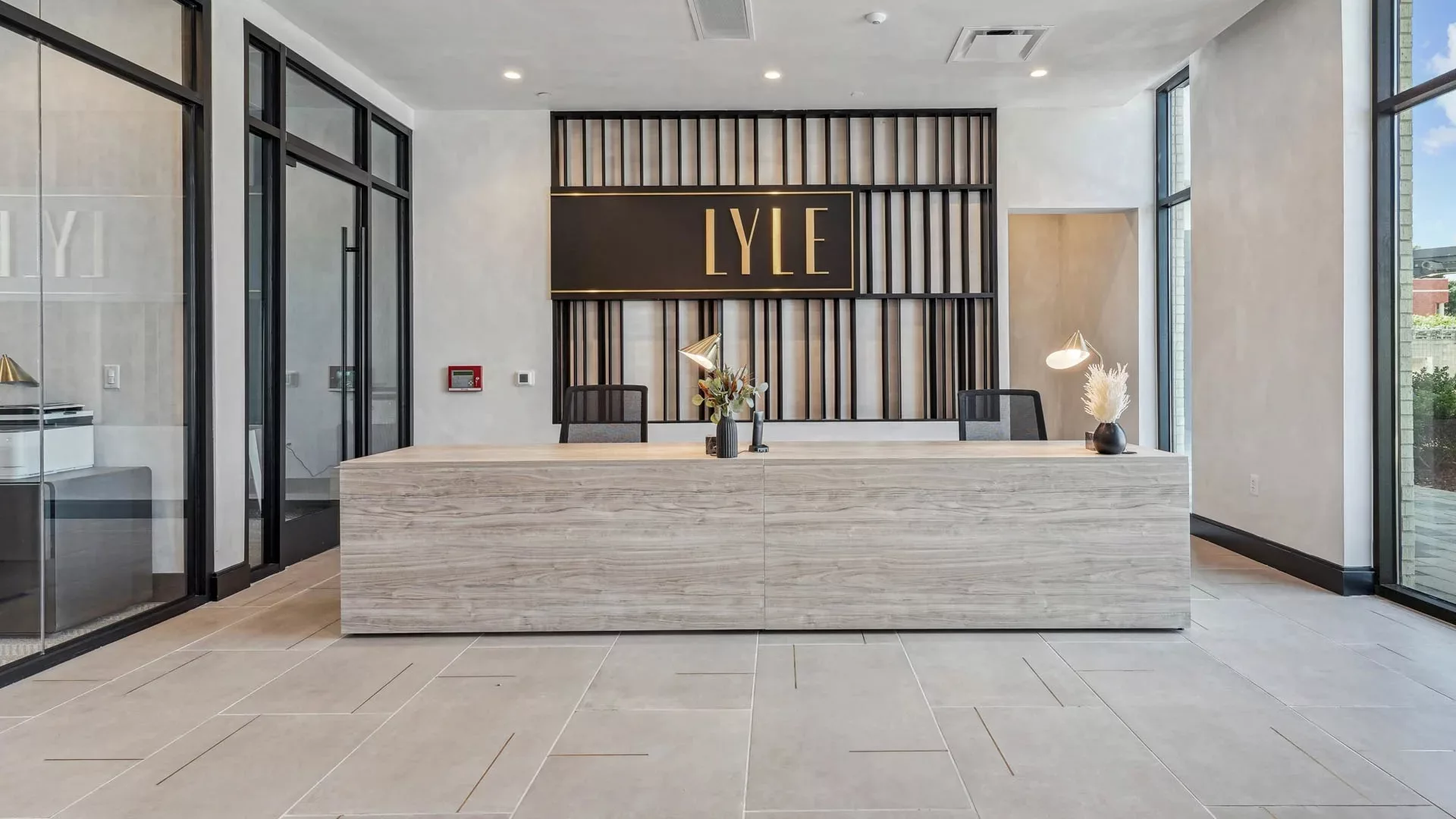 Modern reception desk with “LYLE” sign and decorative lighting