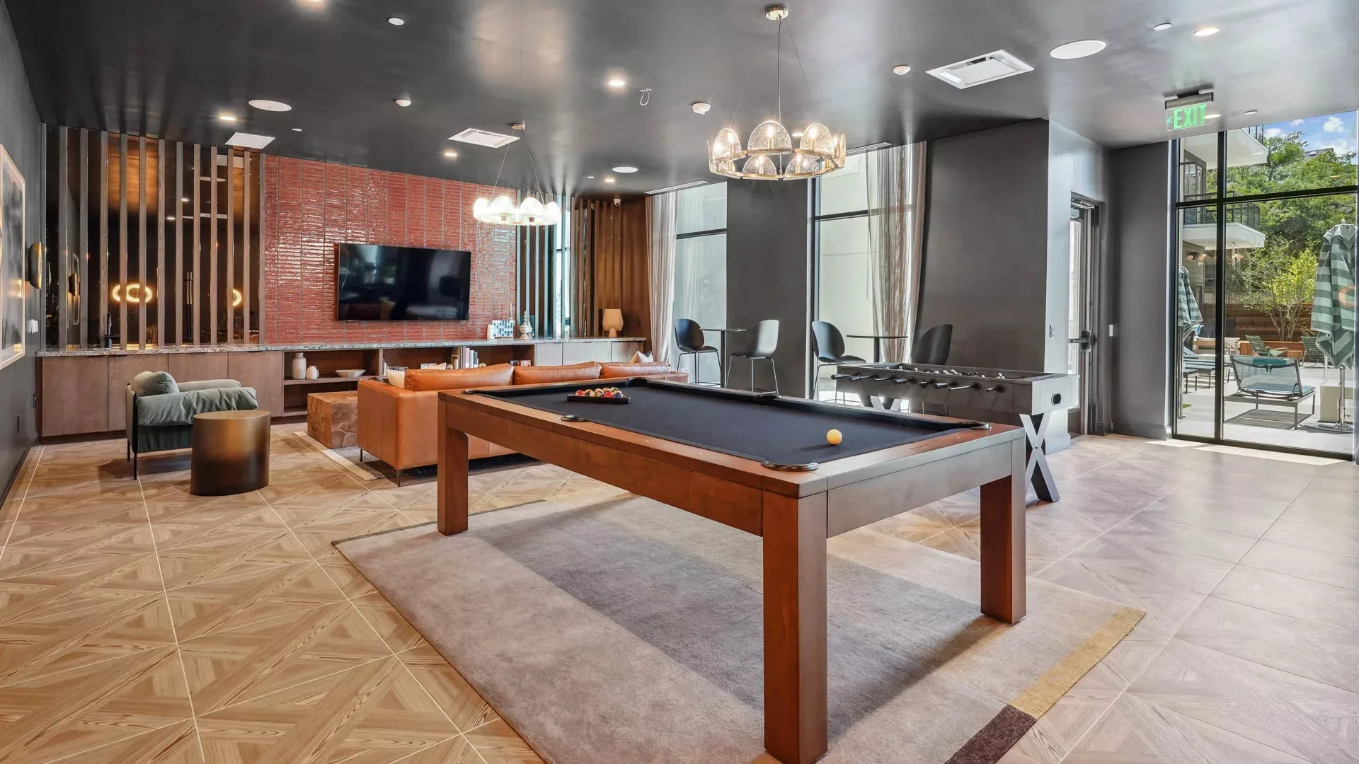 Game room with pool table, foosball, and seating areas