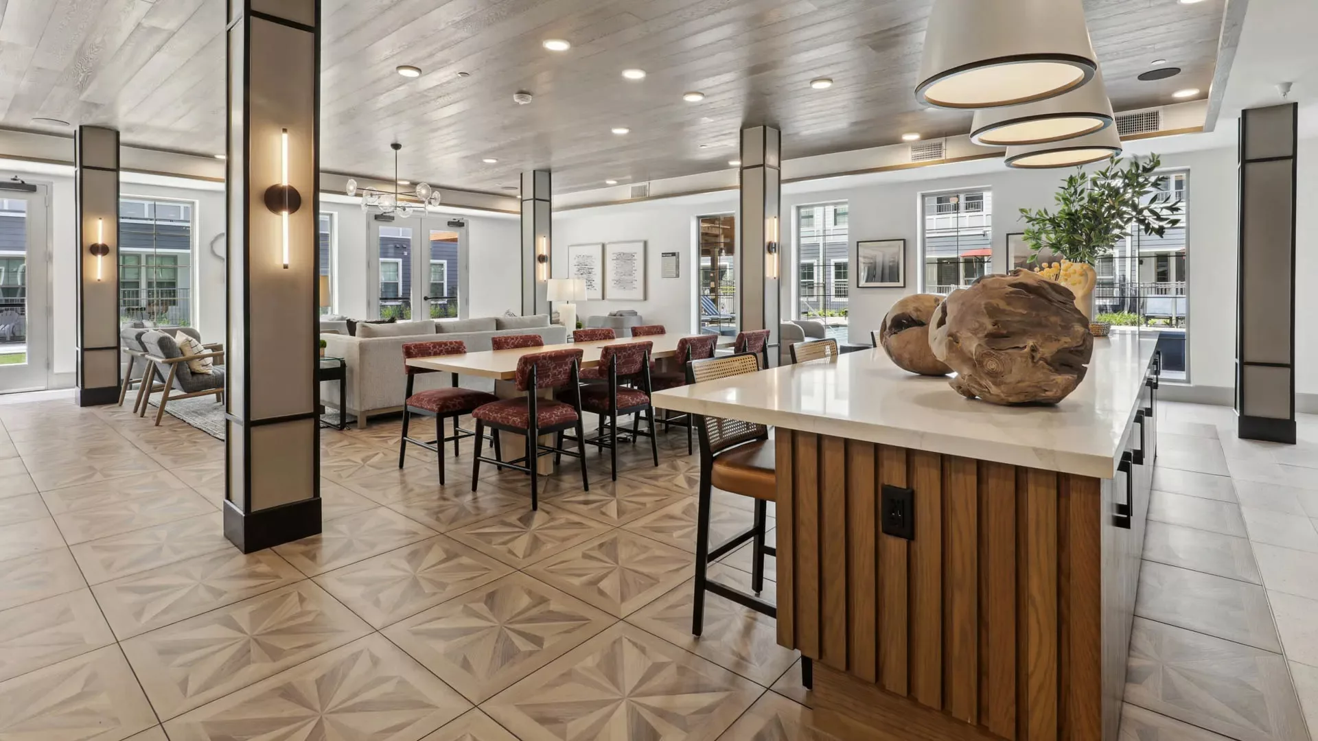 Clubroom with dining tables, island seating, and geometric tile flooring