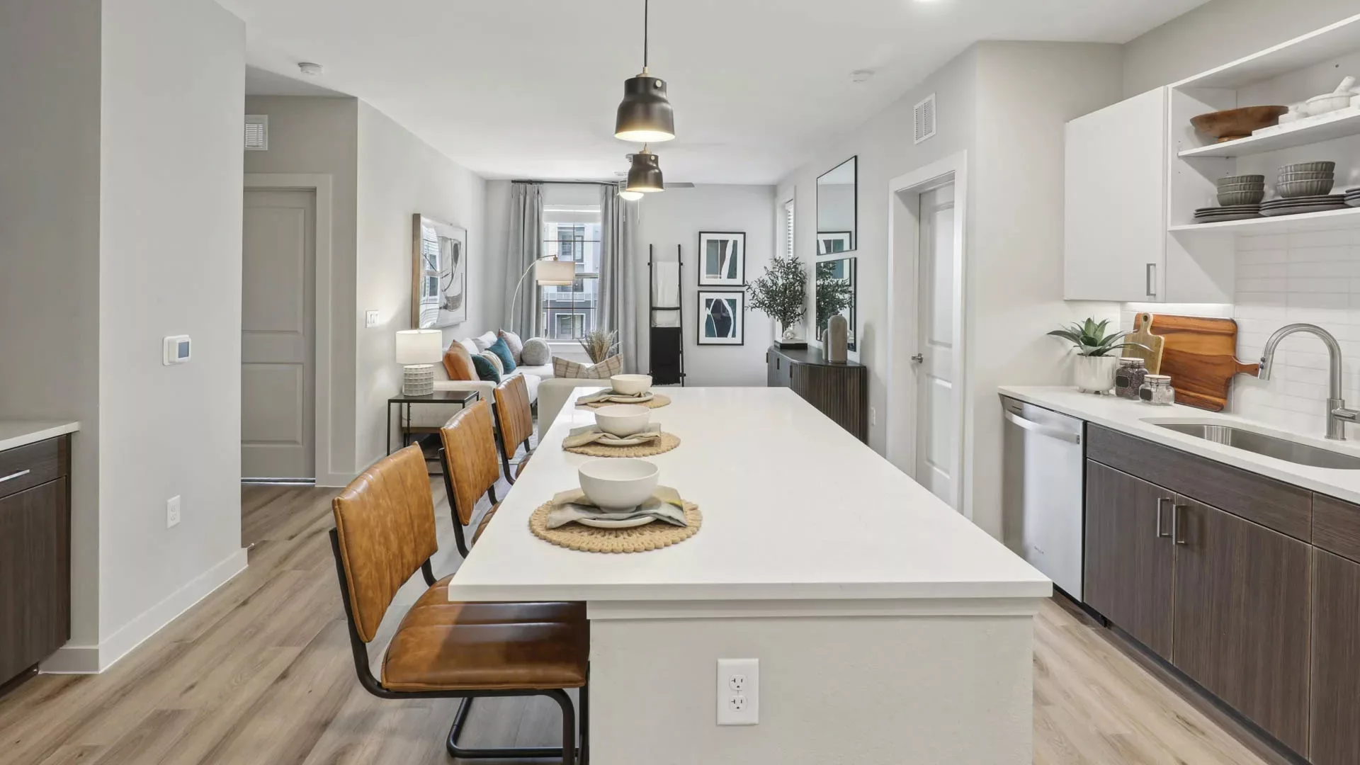 Kitchen with island seating and view into open-plan living area