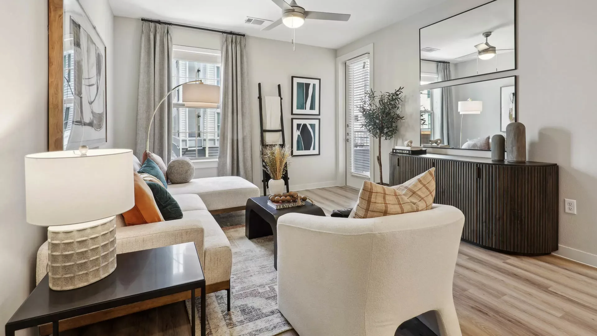 Living room with sectional sofa, armchair, and modern decor