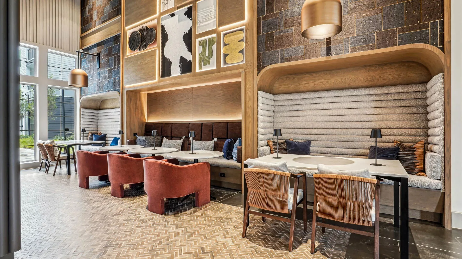 Lounge with booth seating, wall art, and mixed contemporary furnishings