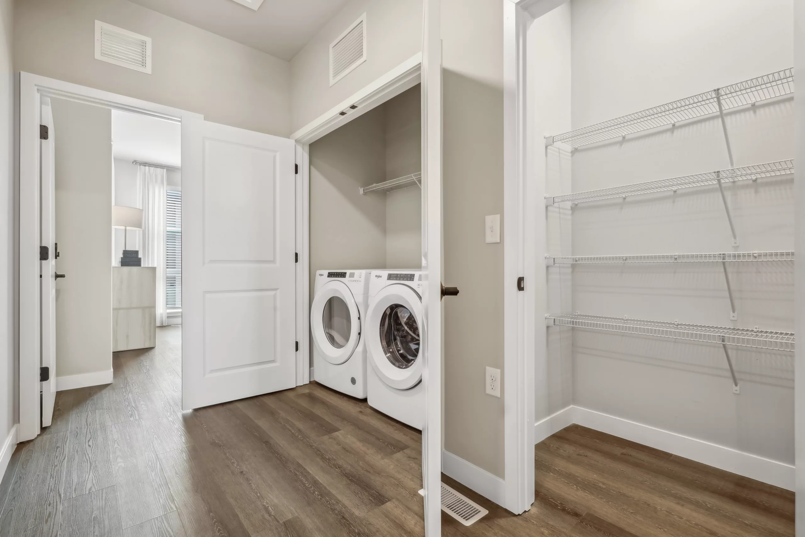Laundry room with washer, dryer, and wire shelving