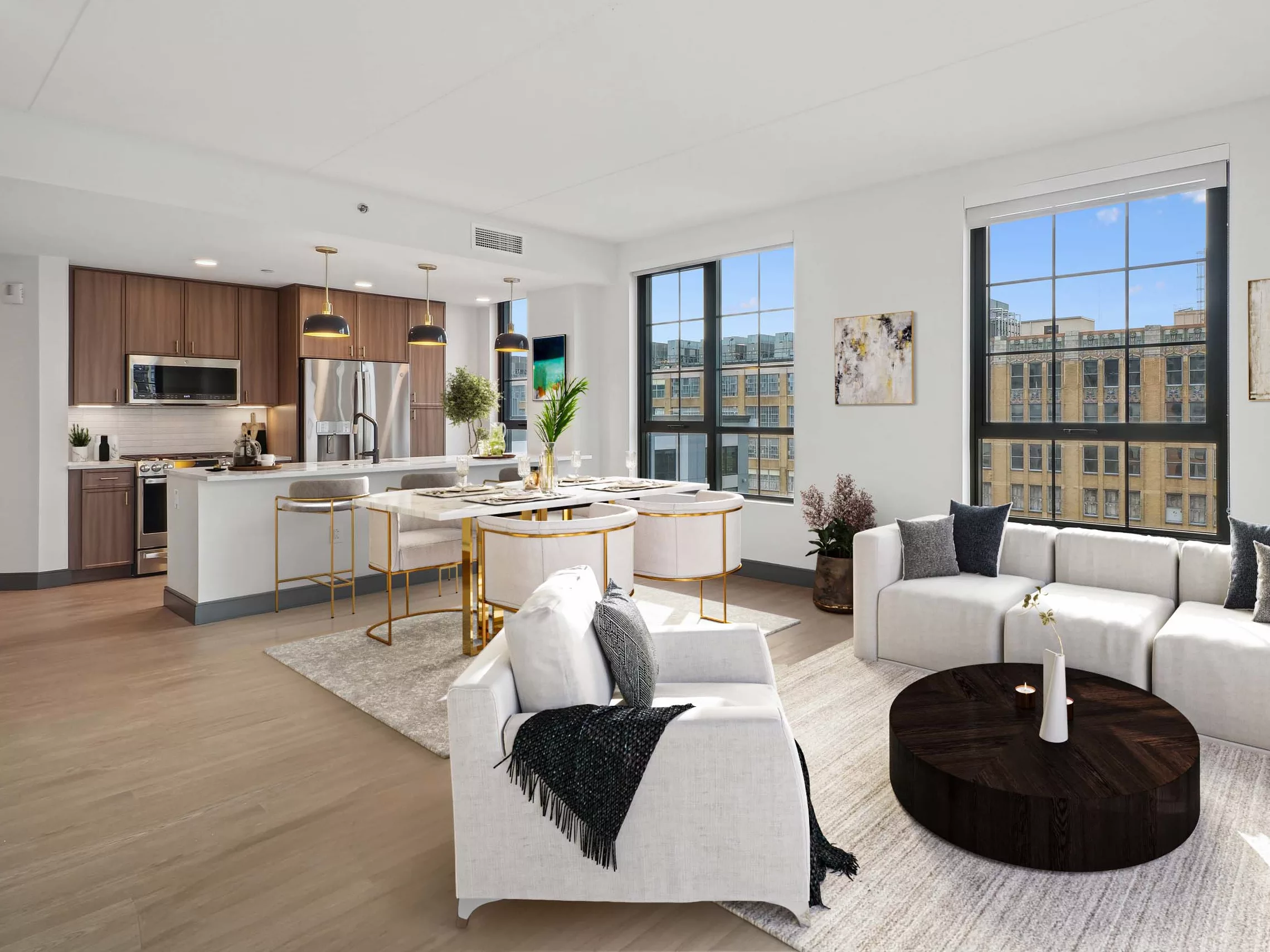 Bright living and dining area with white sofas and panoramic windows.